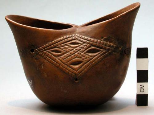 Wooden cup, carved sides