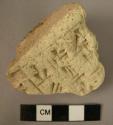 Clay object; fragment; hieroglyphic inscription.