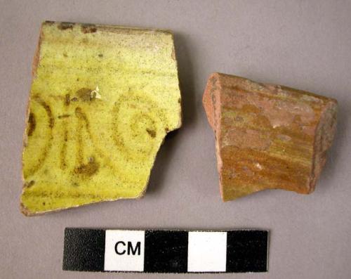 2 rim potsherds - brown on yellow glaze; local