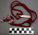 Cord, red finger-woven cord w/ 6 knobs at ends, each decorated w/ white beads