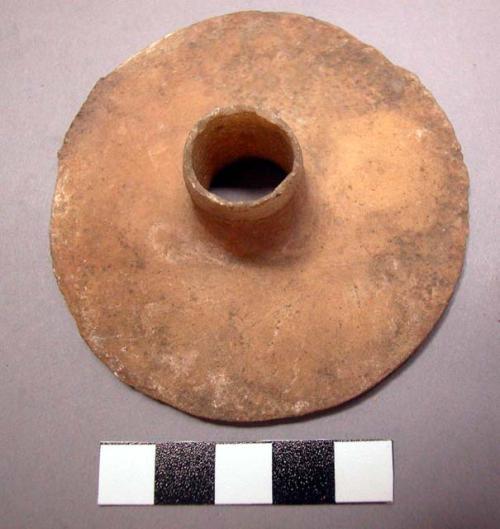 Alabaster disc-like object with perforation