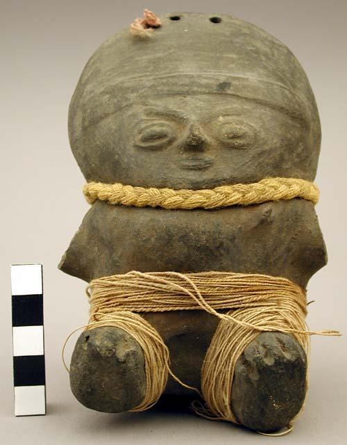 Ceramic, black ware seated human figurine with textile trimming