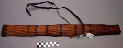 Quiver, closely woven straw, amber color, .25" stripes of black paint, fur sling