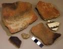 Ceramic rim and body sherds, undecorated, black on white, burnt, red slip