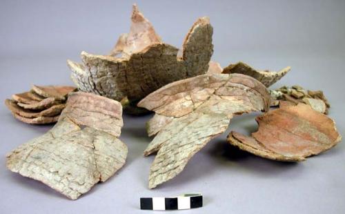 Corrugated pottery jar - red ochre stains inside - partially restored