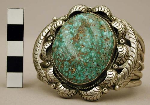 Cuff bracelet with large central turq. stone surrounded by silver leaves