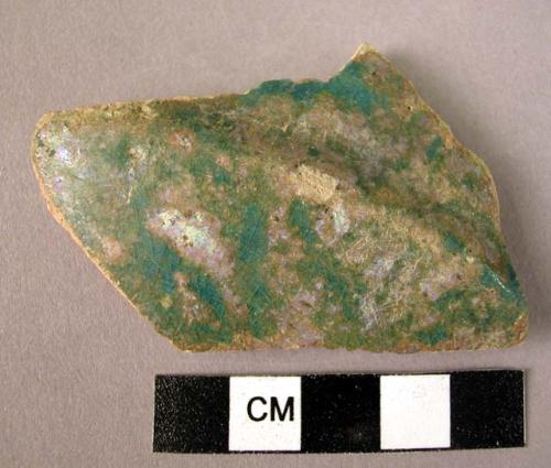 Ceramic body sherd, green irredescent glaze, angular profile