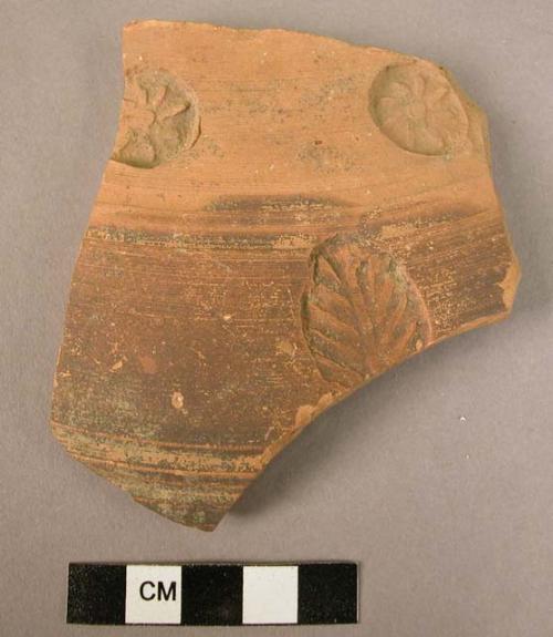 Ceramic body sherd, brown thin glaze, impressed floral designs