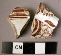 2 potsherds - red-brown on white glaze