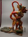 Sculpture, carved and painted standing figure, springed base, 4 brass plates