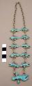 Necklace, silver chain linking 12 small & 1 large "flying men", turquoise inlay