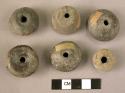 Ceramic spindle whorls, various shapes, perforated, chipped, broken