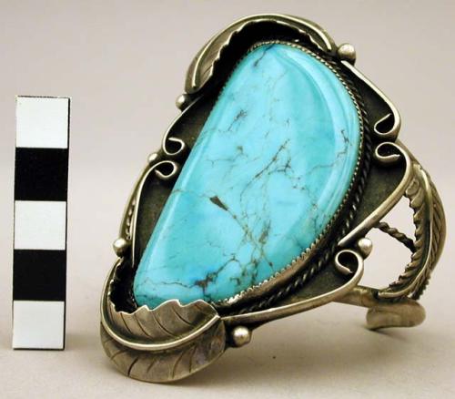Cuff bracelet, large turquoise stone in center flanked by silver leaves