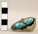 Silver ring, oval turquoise stone in platform setting w/ silver feather on side