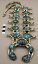 Silver necklace, naja pendant  w/ turq. stones, some set into squash blossoms