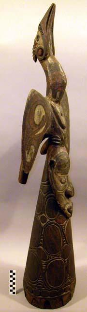 Ridge or gable finial, "with classic sepik river head surmounted by +