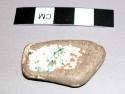 Piece of china coated witth greyish substance, in witch doctor's basket 39-64-50