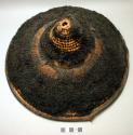 Hat - coiled straw with rough pile exterior; black and tan fibre