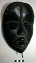 Black wooden mask (To bu Glu) - comes to town when someone dies; all chickens mu