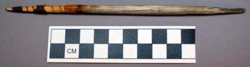 Carved bone shaft, ends slightly tapered, 1 end w/ sinew wrap & rubber? remnants