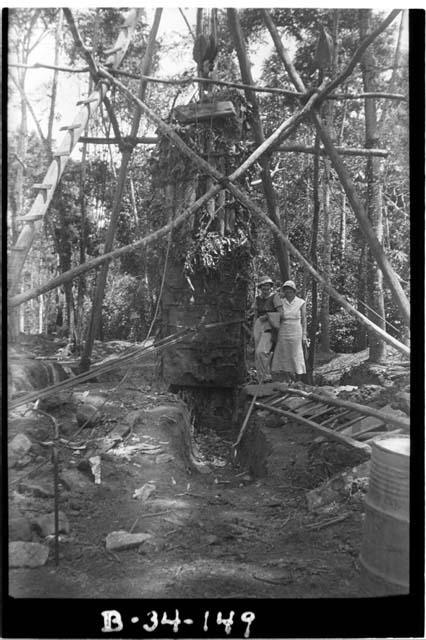 Stela J, hanging in the air, being placed