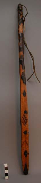 Wooden club with round handle and some incised decoration