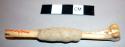 Leg bone of small animal with greyish clay(?) - in Witch Doctor's basket
