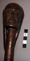 Ceremonial stick with female head carved at one end, 39" long