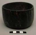 Small wooden bowl with incised decoration filled with red pigment