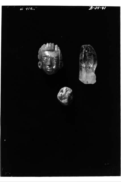 Unworked jade, jade face and crystal from cache of  Zoomorph O