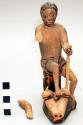 Seated carved wooden figurine