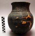 Small clay jar with incised decoration
