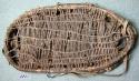 Donkey carrying pack, rim of bent sticks bound with rawhide strips, center webbi