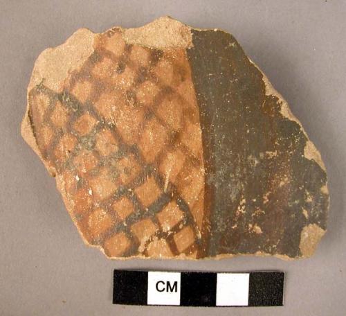 Ceramic body sherd, buff ware with brown painted scale motif