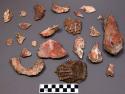 Shell faunal remains, spiny oyster?, white and reddish orange, some spiked ext.