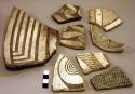 Ceramic rim and body sherds, black on white geometric designs