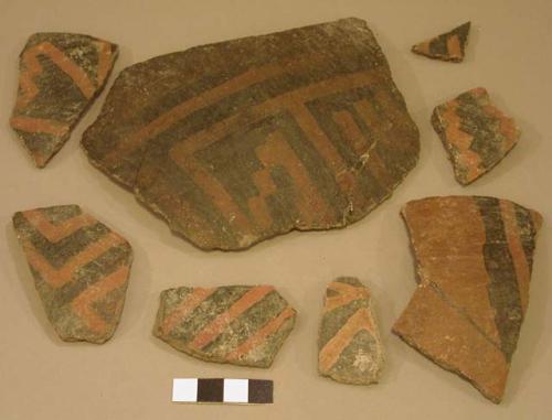 Ceramic rim and body sherds, black on red linear designs, mended