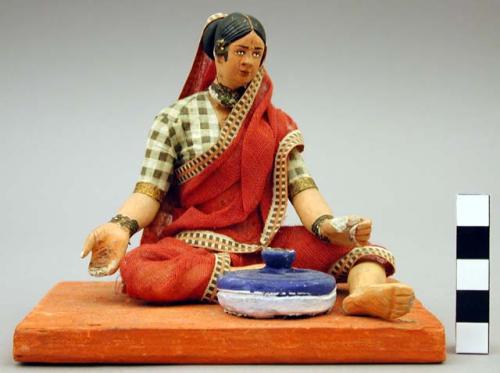 Figurine, seated woman, a scindee embroiderer