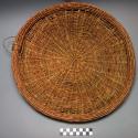 Basketry plate, coarse twine weave, mud plastered on back, kitalu