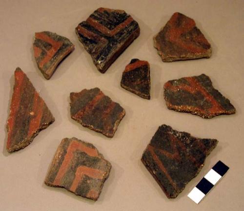 Ceramic rim and body sherds, black on red linear design