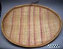 Large basketry plate, wicker weave, oval shape, coiled rim, stripes of cerise, o