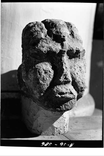 Sculptured head with fat cheeks and heavy brow ridges