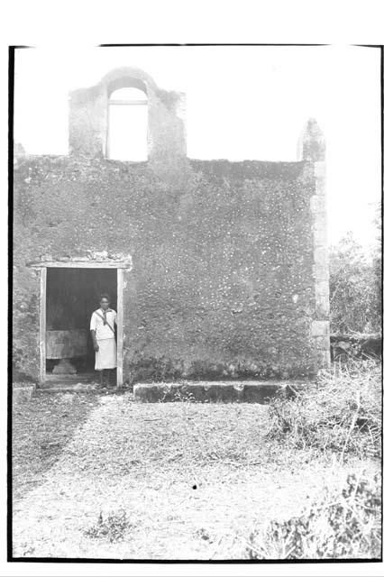 Man standing in doorway of church sacristy