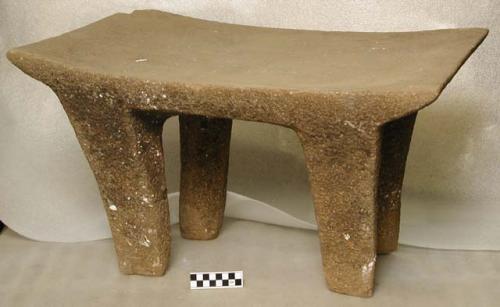 Large four-legged stone metate