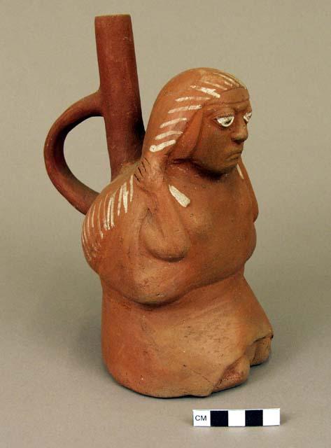 Red stirrup pot in form of woman