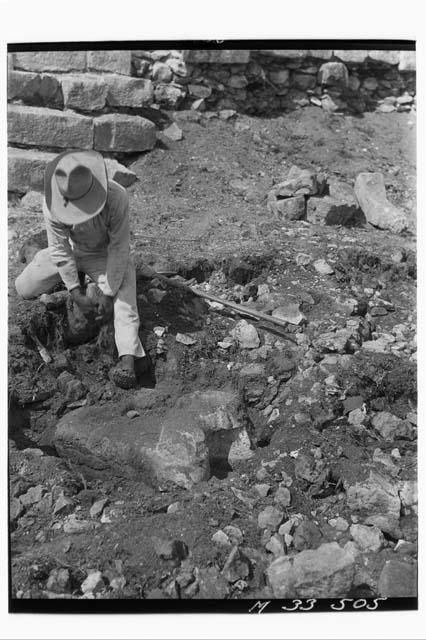 Unearthing Chac Mool at base of main stairs at Monjas, from North