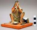 Figurine, seated woman, bread maker, right hand broken off but present