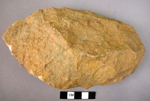 Large quartzite hand axe roughly oval in form with trimmed butt