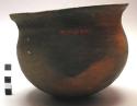 Pottery cooking pot, black, small, incised decoration on outcurving rim (mbikasa