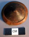 Ornament, leather covered conical object,  lighter leather ring at  perimeter, s